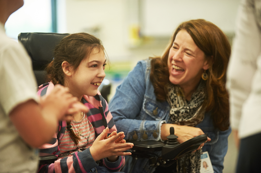 Northwest AEA employee working with a student in a wheelchair